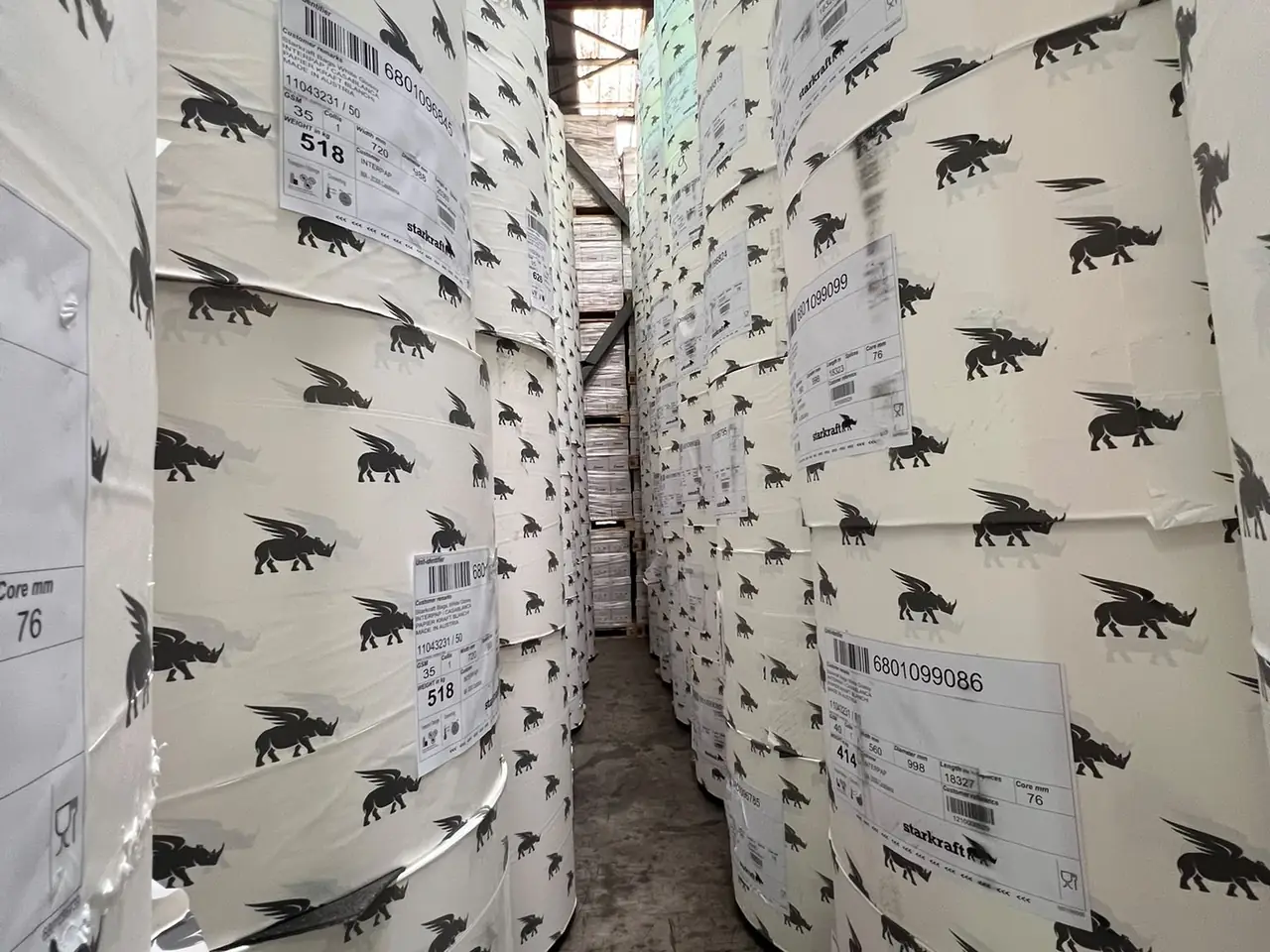 Aisle between Starkraft paper reels in stock at an INTERPAP warehouse